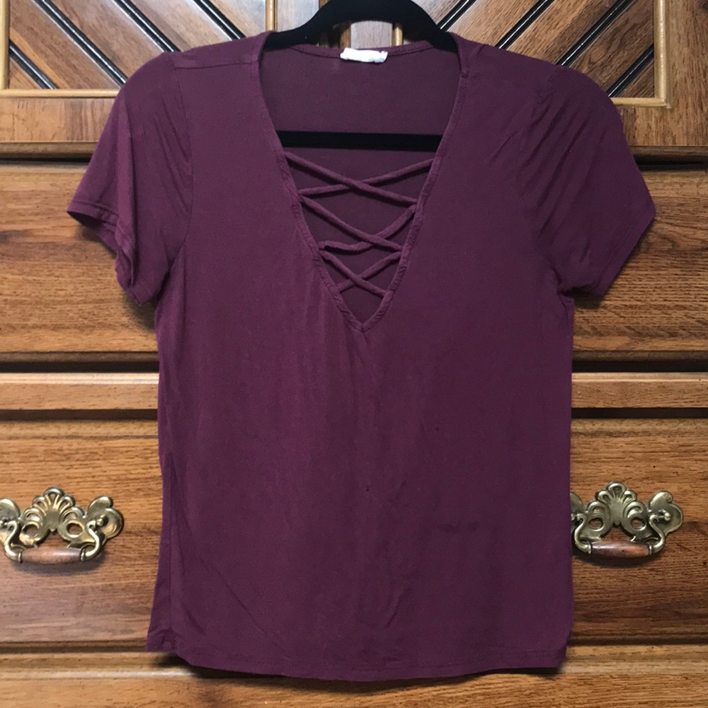 maroon v neck top with crosses on the chest